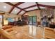 Bright living room with vaulted ceilings, stone fireplace, and hardwood flooring at 211 Black Kettle Ln, Johns Creek, GA 30022