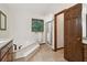A bright bathroom features a soaking tub and walk-in shower at 211 Black Kettle Ln, Johns Creek, GA 30022