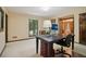 Neutral toned office with a large desk, and lots of natural light overlooking the backyard at 211 Black Kettle Ln, Johns Creek, GA 30022