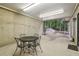 Covered patio with concrete flooring and a metal table and chairs to enjoy the outdoors at 211 Black Kettle Ln, Johns Creek, GA 30022
