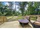 Relaxing backyard deck with comfortable seating and a view of the lush green space at 217 Penelope Nw Dr, Atlanta, GA 30314