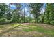 Lush backyard featuring mature trees and a well maintained lawn, providing a private outdoor oasis at 217 Penelope Nw Dr, Atlanta, GA 30314