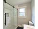 Elegant bathroom featuring a glass-enclosed shower, white subway tile, and modern fixtures at 217 Penelope Nw Dr, Atlanta, GA 30314