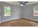 A spacious bedroom with wood flooring, light gray walls, and a ceiling fan at 217 Penelope Nw Dr, Atlanta, GA 30314