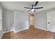 A serene bedroom with wood floors, modern ceiling fan, and bright natural light at 217 Penelope Nw Dr, Atlanta, GA 30314