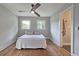 Bright bedroom featuring hardwood floors, a ceiling fan, and two windows offering natural light at 217 Penelope Nw Dr, Atlanta, GA 30314