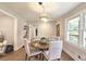 Cozy dining room featuring a round table, stylish chairs, a modern light fixture, and hardwood floors at 217 Penelope Nw Dr, Atlanta, GA 30314