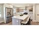 Modern kitchen with stainless steel appliances, white cabinets, quartz countertops, and a stylish island with seating at 217 Penelope Nw Dr, Atlanta, GA 30314