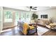 Living room with a comfortable sofa, stylish decor, hardwood floors, and large windows for natural light at 217 Penelope Nw Dr, Atlanta, GA 30314