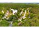 An aerial view shows the neighborhood with lush greenery surrounding a serene lake at 4444 Bending River Sw Trl, Lilburn, GA 30047