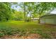 Expansive backyard with mature trees, providing privacy and a serene outdoor space at 4444 Bending River Sw Trl, Lilburn, GA 30047