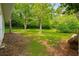 Backyard with mature trees that provide lots of shade at 4444 Bending River Sw Trl, Lilburn, GA 30047
