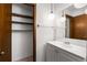 Bathroom featuring globe lights, a white vanity, and closet space at 4444 Bending River Sw Trl, Lilburn, GA 30047