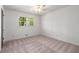 Bright bedroom featuring a ceiling fan and natural light from a window at 4444 Bending River Sw Trl, Lilburn, GA 30047