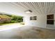 Carport area featuring concrete floor and access door at 4444 Bending River Sw Trl, Lilburn, GA 30047
