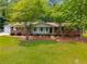 Well-kept single-story brick home featuring a spacious front yard and attached garage at 4444 Bending River Sw Trl, Lilburn, GA 30047