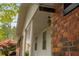 Close-up of the home's entrance with brickwork, white columns and a hanging lantern at 4444 Bending River Sw Trl, Lilburn, GA 30047