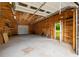 Spacious garage with exposed rafters and built-in shelving, offering ample storage at 4444 Bending River Sw Trl, Lilburn, GA 30047