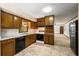 Traditional kitchen featuring wooden cabinets and open access to the living area at 4444 Bending River Sw Trl, Lilburn, GA 30047