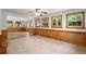 Bright living room with wood paneling, many windows, and tile flooring at 4444 Bending River Sw Trl, Lilburn, GA 30047