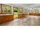 Bright living room with wood paneling, backyard access, and tile flooring at 4444 Bending River Sw Trl, Lilburn, GA 30047