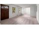 Open-concept living room features a front door and flows into the dining room at 4444 Bending River Sw Trl, Lilburn, GA 30047