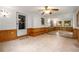 Spacious living room with wood paneling, tile flooring, and backyard access at 4444 Bending River Sw Trl, Lilburn, GA 30047