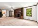 Living room showcasing a brick fireplace, wood built-ins, and plenty of natural light at 4444 Bending River Sw Trl, Lilburn, GA 30047
