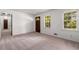 Bright living room with neutral carpet, multiple windows, and natural light at 4444 Bending River Sw Trl, Lilburn, GA 30047