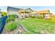 Manicured backyard features a lush lawn, covered patio, and meticulous landscaping at 5641 Tisbury Ct, Hoschton, GA 30548