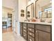 Bathroom with double vanity, updated fixtures, and a walk-in shower; walk-in closet in background at 5641 Tisbury Ct, Hoschton, GA 30548