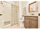 Cozy bathroom featuring a shower/tub combo, neutral-colored vanity and a framed mirror at 5641 Tisbury Ct, Hoschton, GA 30548