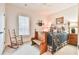 Charming bedroom with decorative accents, and a rocking chair near the window at 5641 Tisbury Ct, Hoschton, GA 30548