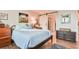 Bright bedroom features a comfortable bed, wood floors, and a barn-style door leading to the bathroom at 5641 Tisbury Ct, Hoschton, GA 30548