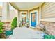 Cozy covered front porch with seating and charming decor at 5641 Tisbury Ct, Hoschton, GA 30548