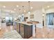 Stylish kitchen island with ample seating and modern lighting at 5641 Tisbury Ct, Hoschton, GA 30548