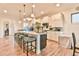Spacious kitchen boasts a large center island with seating and modern pendant lighting at 5641 Tisbury Ct, Hoschton, GA 30548