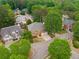 Overhead shot of a well-maintained home nestled in a leafy neighborhood with tree-lined streets and curb appeal at 710 Glen Royal Dr, Roswell, GA 30076