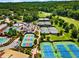 Stunning aerial view of community tennis courts, clubhouse, and pool surrounded by lush landscaping at 710 Glen Royal Dr, Roswell, GA 30076