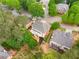 Aerial view of a house nestled among mature trees, featuring a deck and well-maintained landscaping at 710 Glen Royal Dr, Roswell, GA 30076