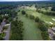 Scenic aerial shot of a golf course featuring lush greens, tree-lined fairways, and nearby residential community at 710 Glen Royal Dr, Roswell, GA 30076