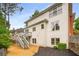 Exterior featuring a charming two-story home with a cozy back deck and landscaped yard with vibrant greenery at 710 Glen Royal Dr, Roswell, GA 30076