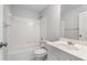 Clean and bright bathroom with a shower-tub combo, white tiling, and a classic vanity at 710 Glen Royal Dr, Roswell, GA 30076