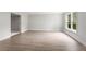 A bright, flexible space featuring light wood floors, offering ample natural light at 710 Glen Royal Dr, Roswell, GA 30076