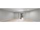 A sprawling bonus room with soft carpet and a large glass door leading to the outside at 710 Glen Royal Dr, Roswell, GA 30076