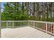 Open white wooden deck with white railings overlooking a wooded area at 710 Glen Royal Dr, Roswell, GA 30076