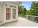 Spacious outdoor deck with white railings and a view of the surrounding trees at 710 Glen Royal Dr, Roswell, GA 30076