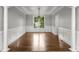 Spacious dining room boasts hardwood floors, wainscoting, decorative columns, and ample natural light at 710 Glen Royal Dr, Roswell, GA 30076