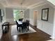 Dining room with hardwood floors, wainscoting, stylish table and chairs at 710 Glen Royal Dr, Roswell, GA 30076