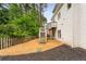 Back exterior view of home showcasing wood siding, privacy fence and access to upper deck at 710 Glen Royal Dr, Roswell, GA 30076